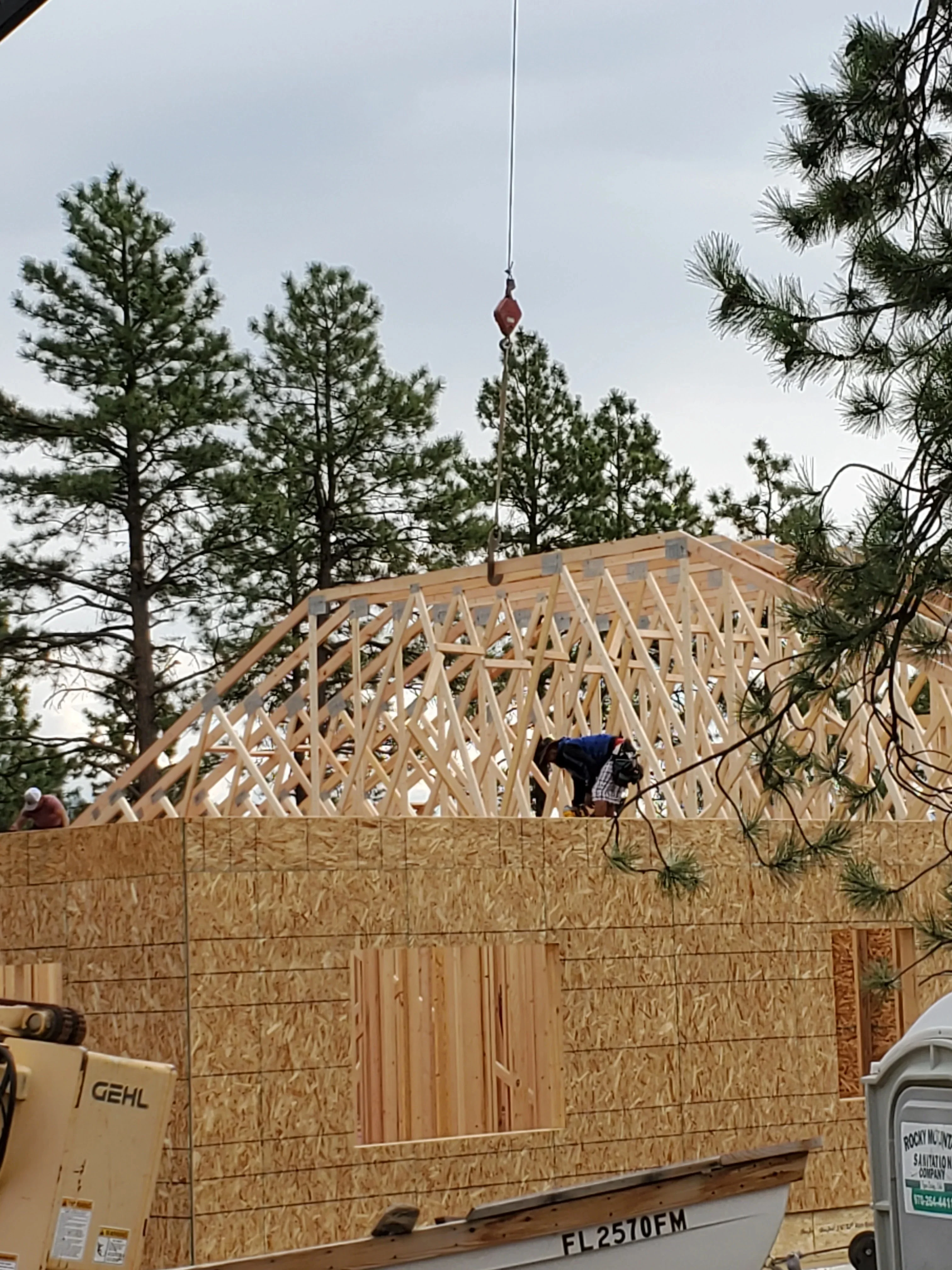 Wooden roof trusses and engineered framing during residential construction with OSB sheathing